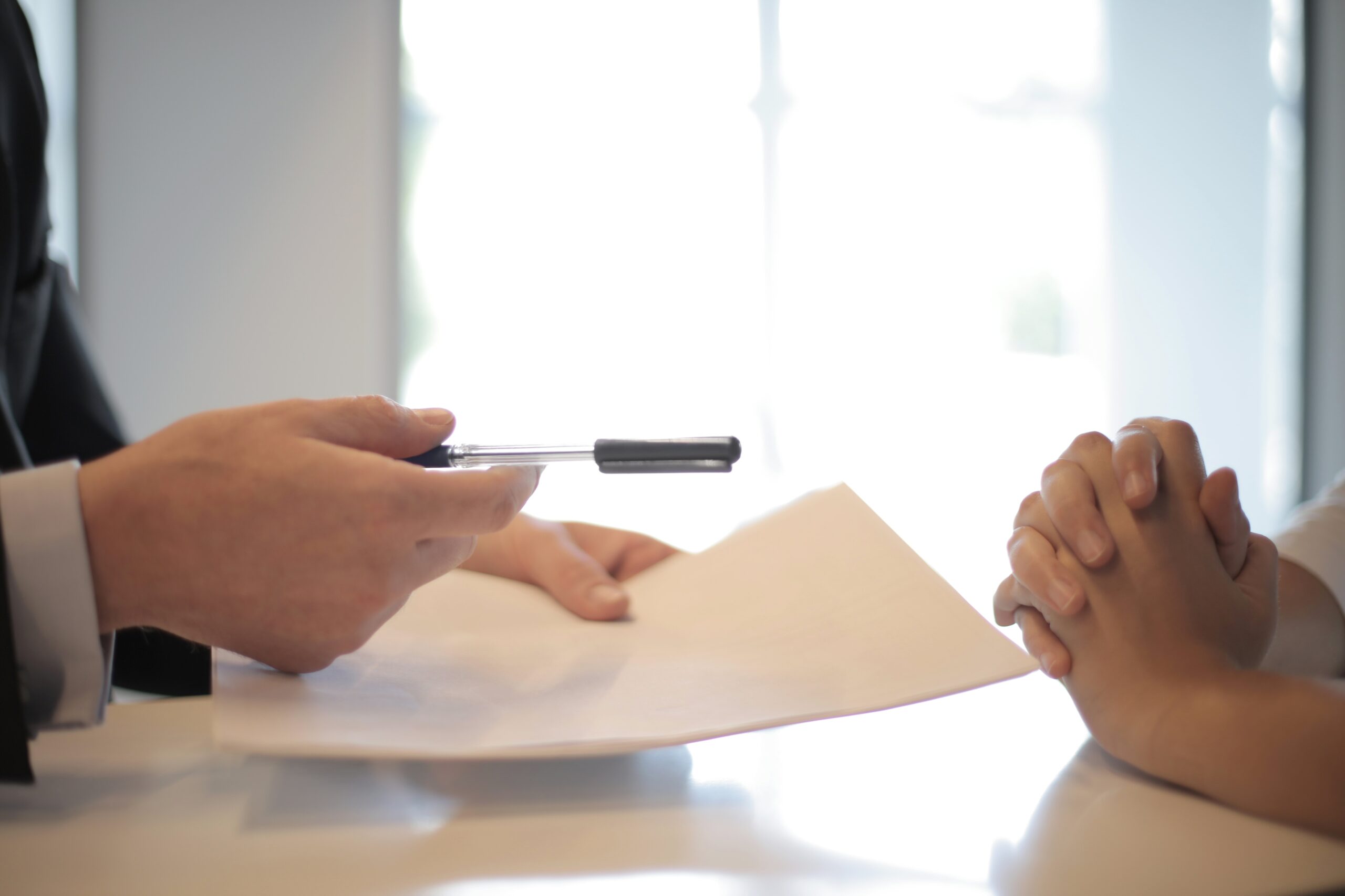 handing over pen and paper
